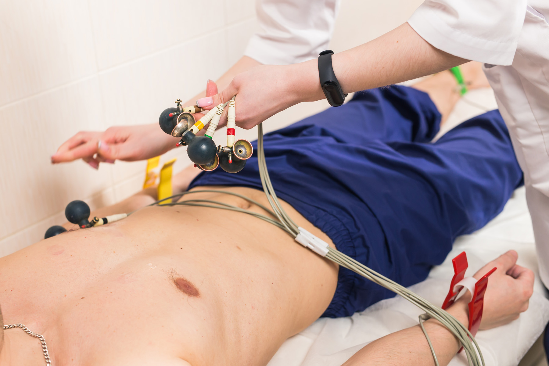 health and heart check-up concept - Male patient having ECG electrocardiogram in hospital